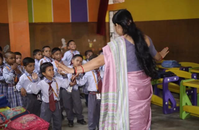 Teacher with young students in class at Daffodil International School